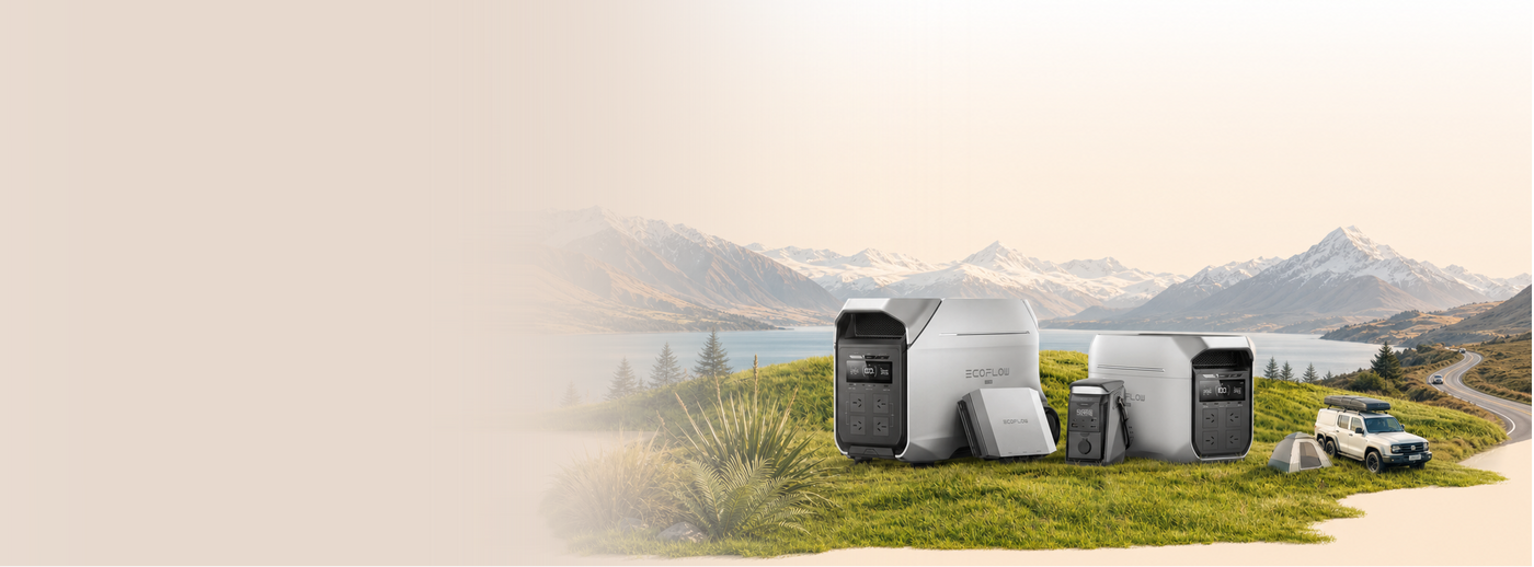 Solar panels on a grassy area with mountains in the background